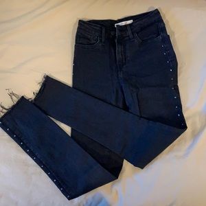 Levi’s black skinny jeans with gem on side